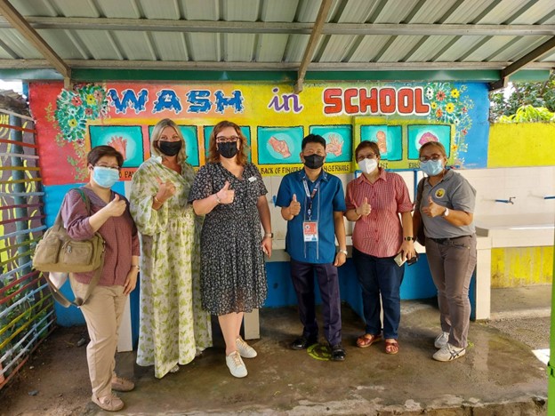 ECU and AU officials pose with Mr. Noel de Guzman, Principal of Masalipit Elementary School in one of the donated handwashing areas within the school premises.